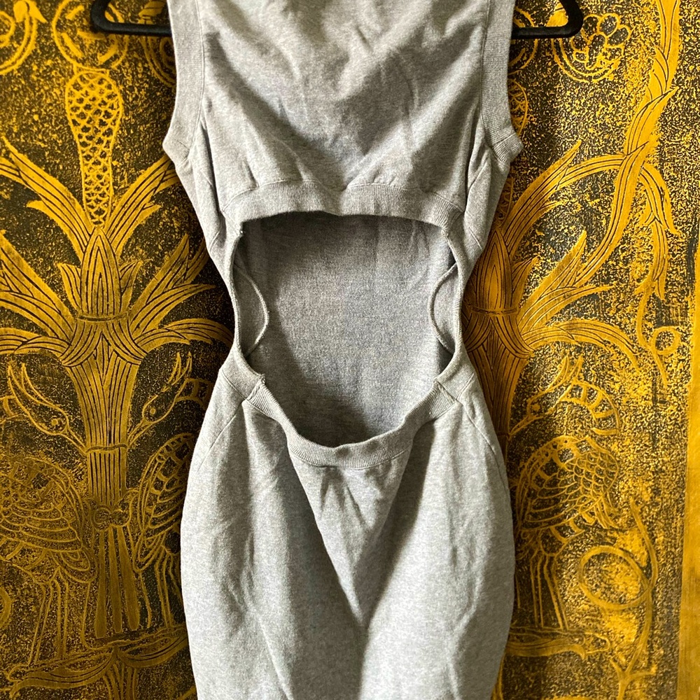 BEBE Stretchy cotton mini dress with a cut out back.